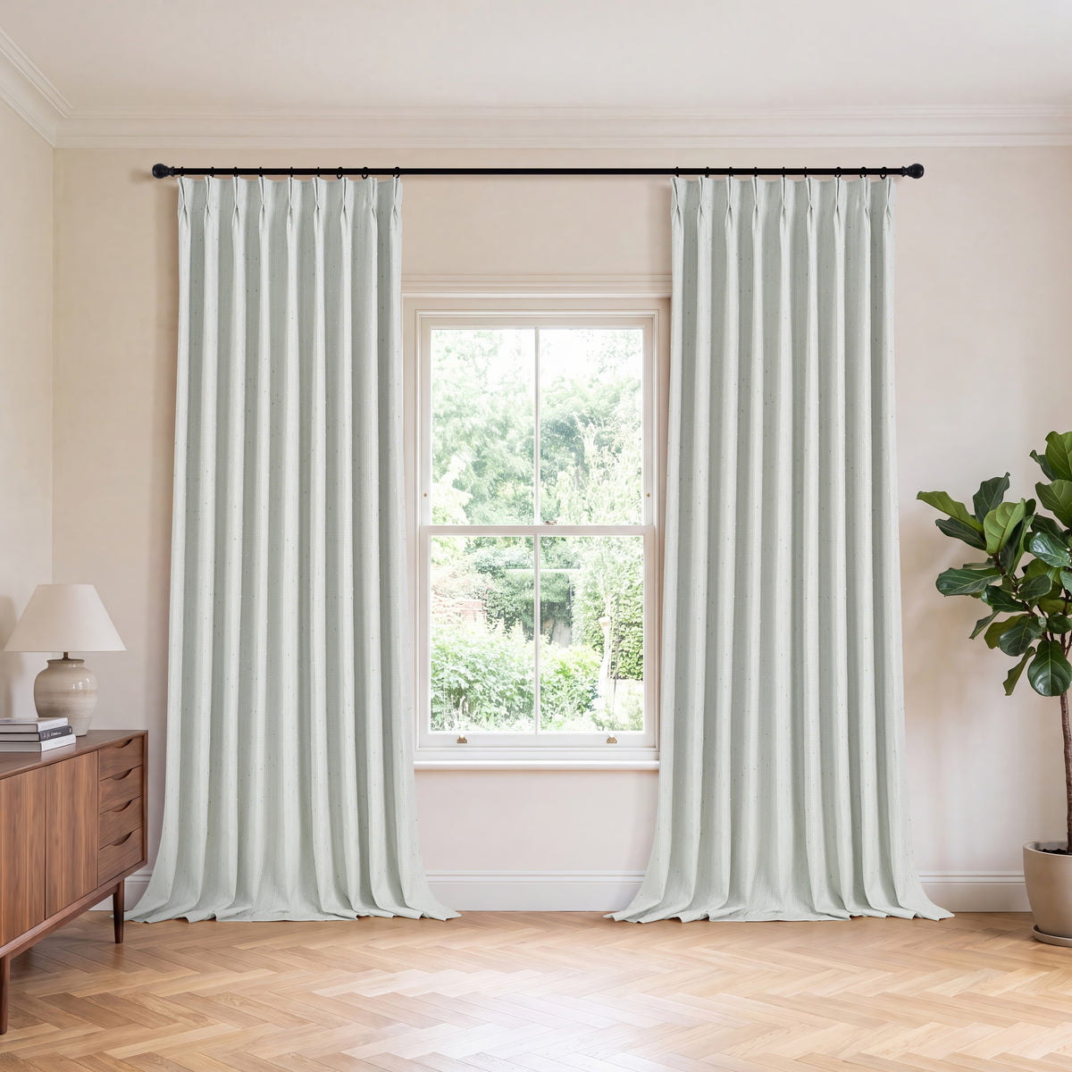 Clarice Tonal Jacquard Blackout Curtains in Light Green, hanging in a room