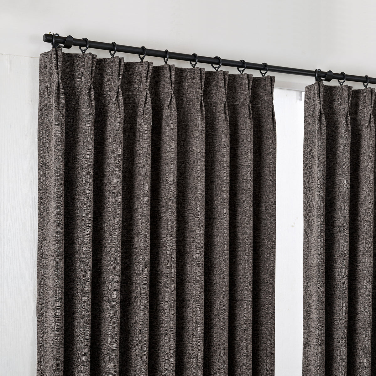 Everett Yarn-Dyed Jacquard Blackout Curtains in Ink, hanging at the window