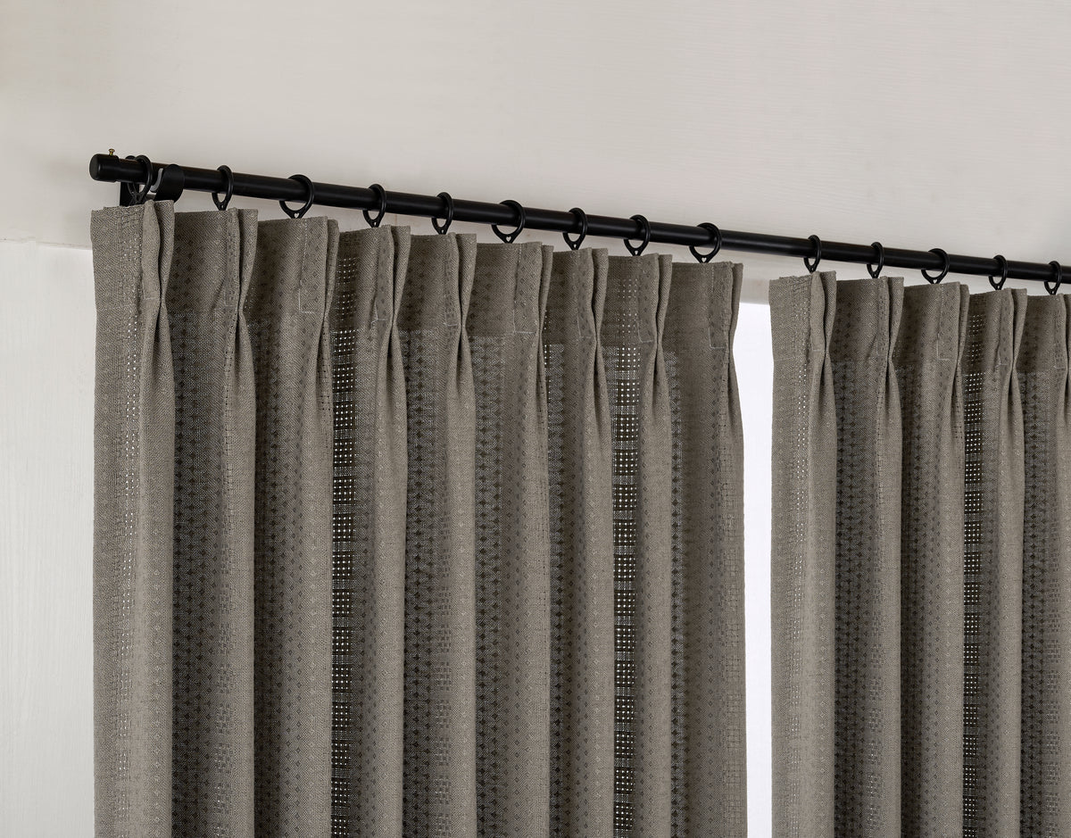 Ansel Eyelet Weave Curtains in Charcoal, hanging at the window