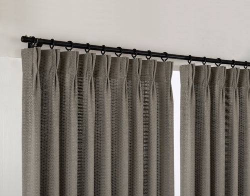 Ansel Eyelet Weave Curtains in Charcoal, hanging at the window