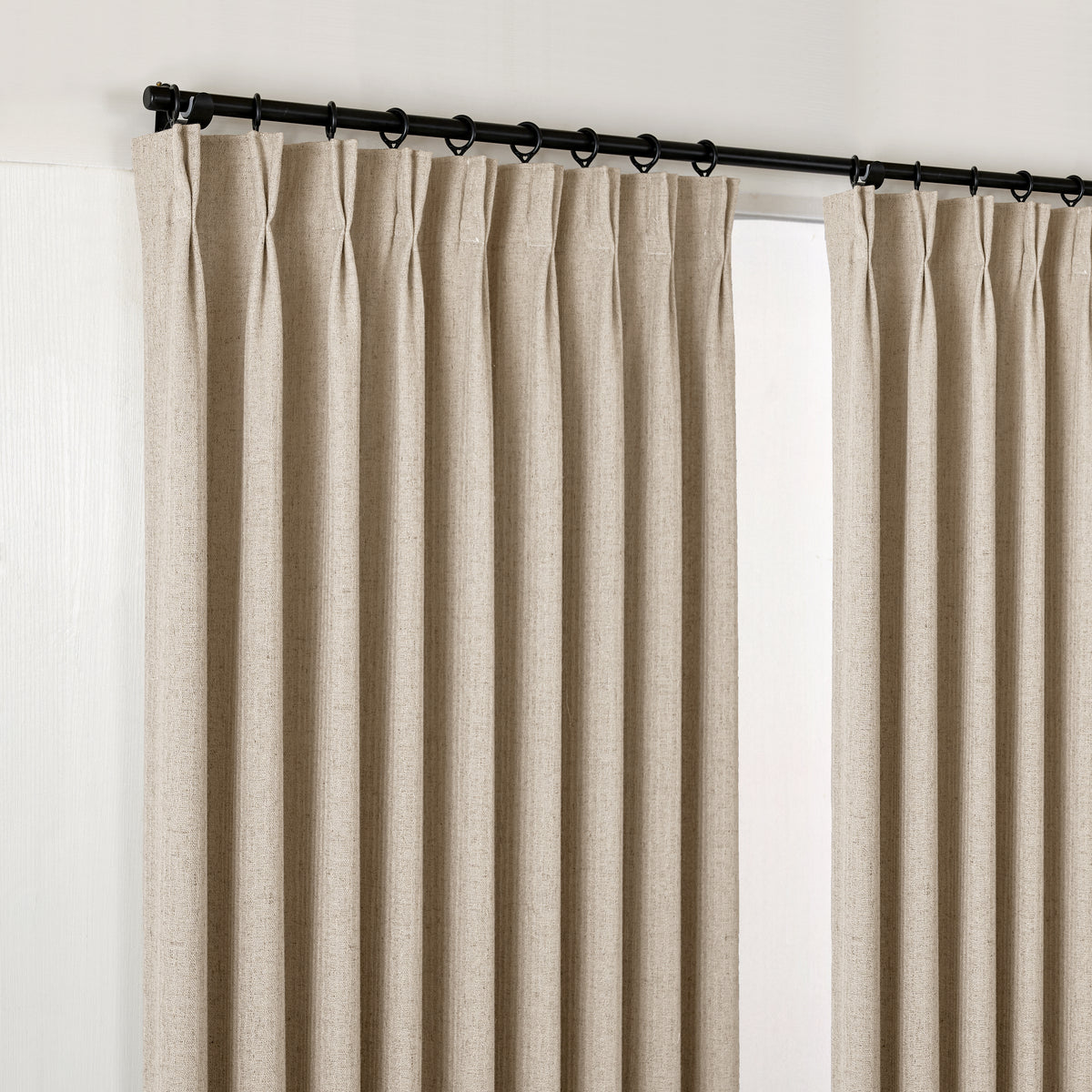 Ansel Slub Weave Curtains in Pale Stone, hanging at the window