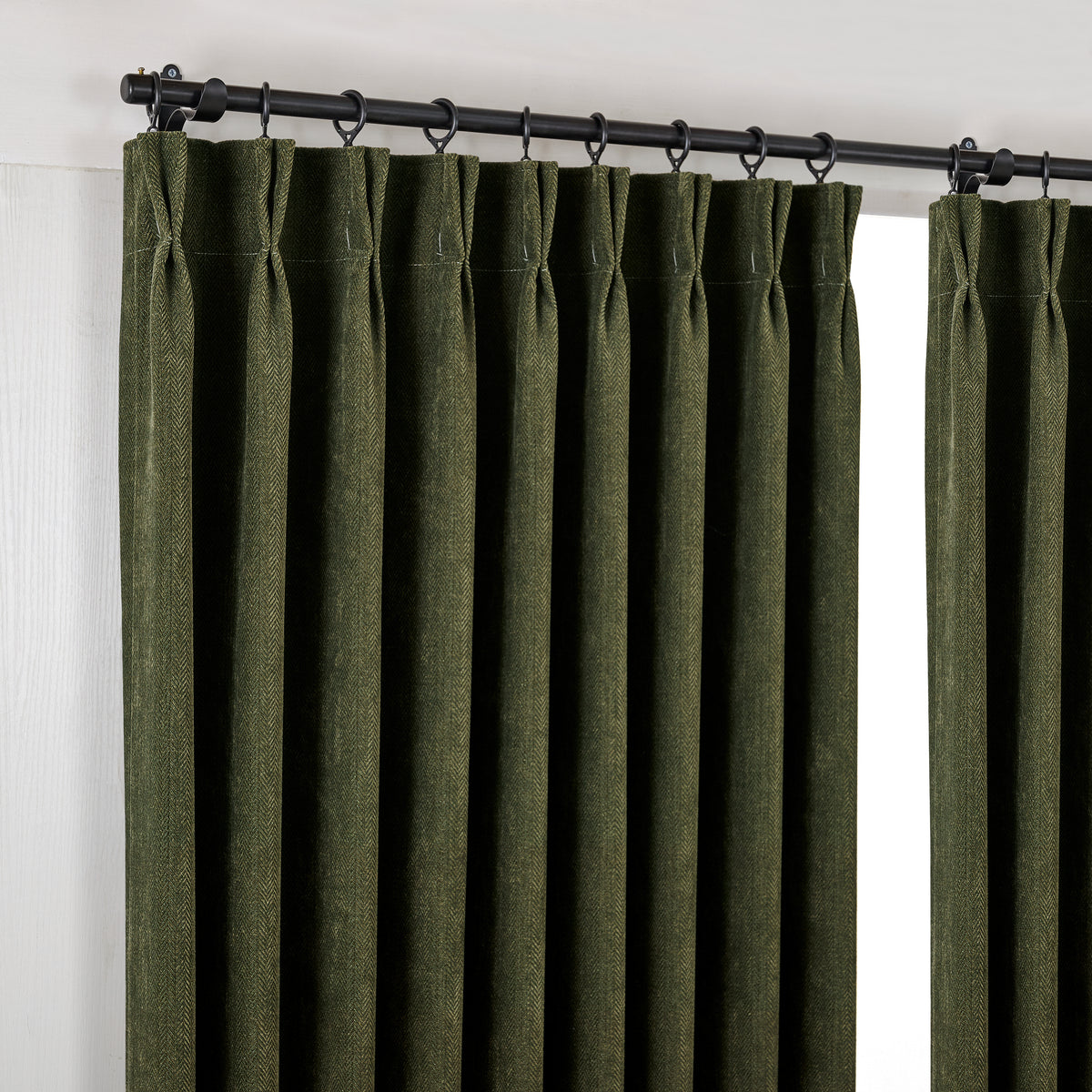Hadleigh Herringbone Blackout Curtains in Forest, hanging at the window