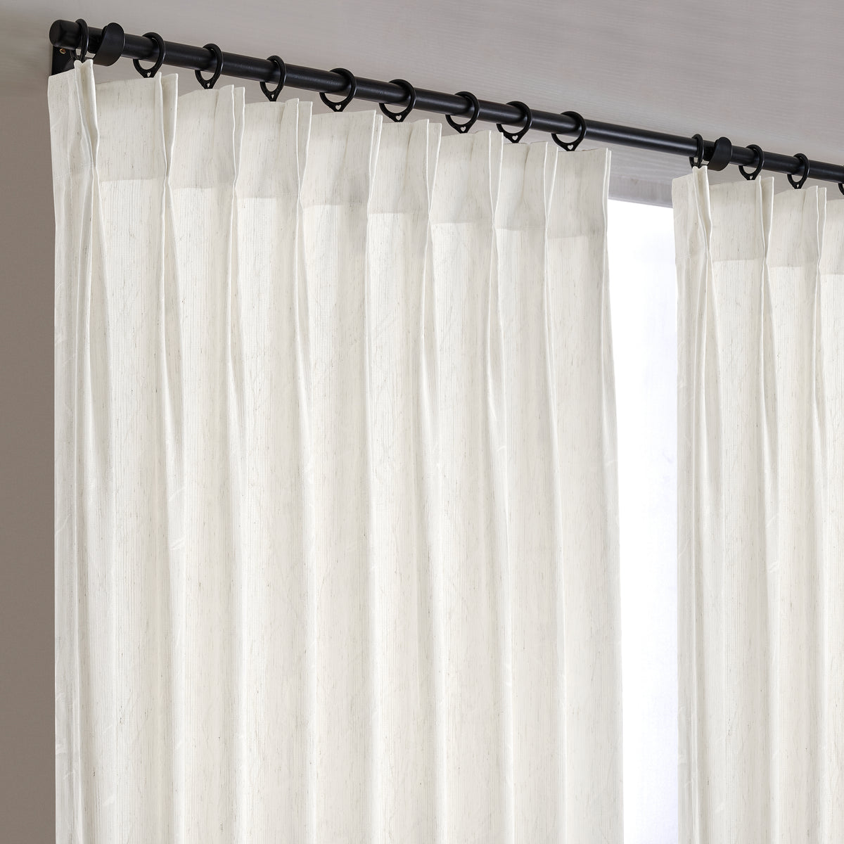 Odile Reed Sheer Curtains in White, hanging at the window
