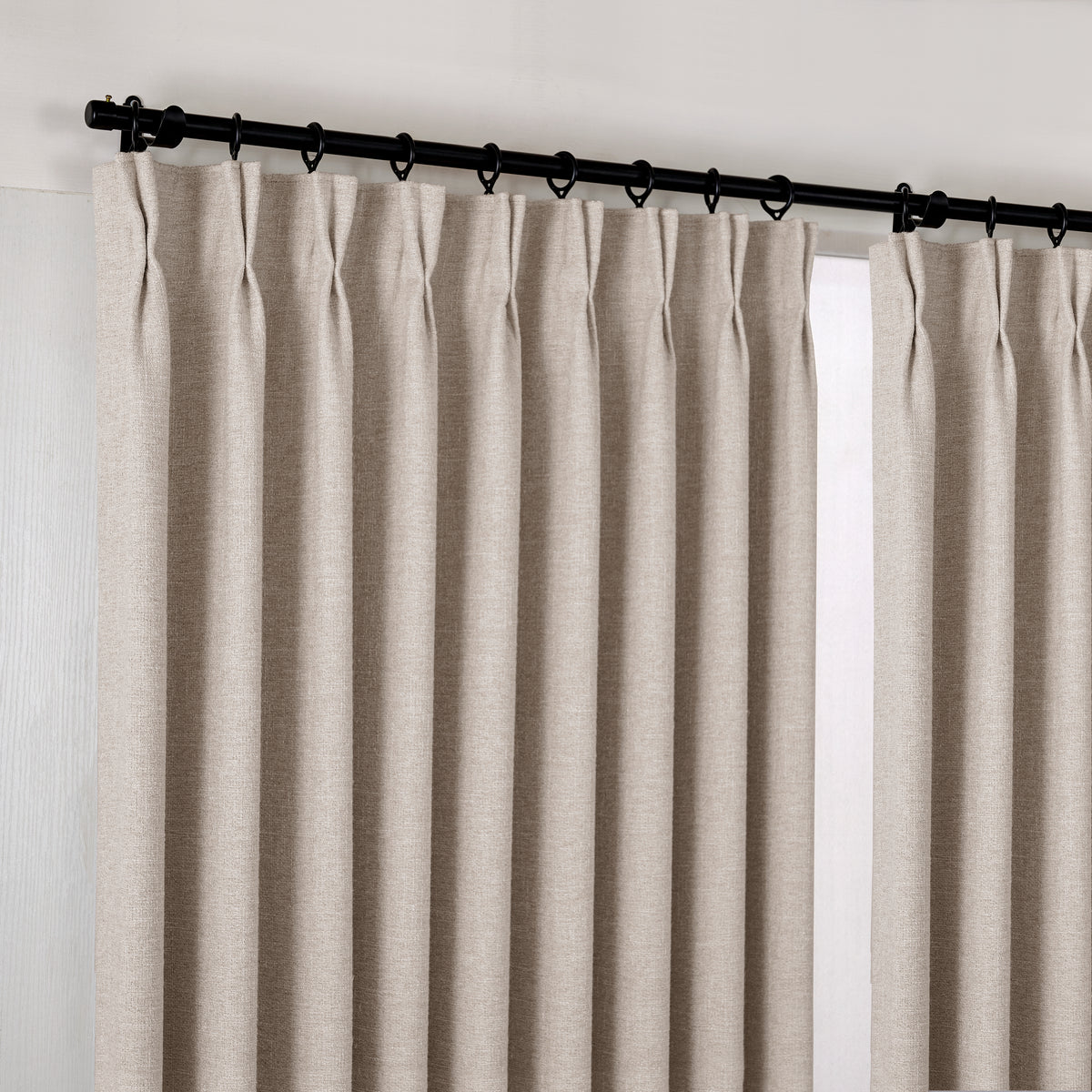 Tamsin Melange Weave Blackout Curtains in Flax, hanging at the window
