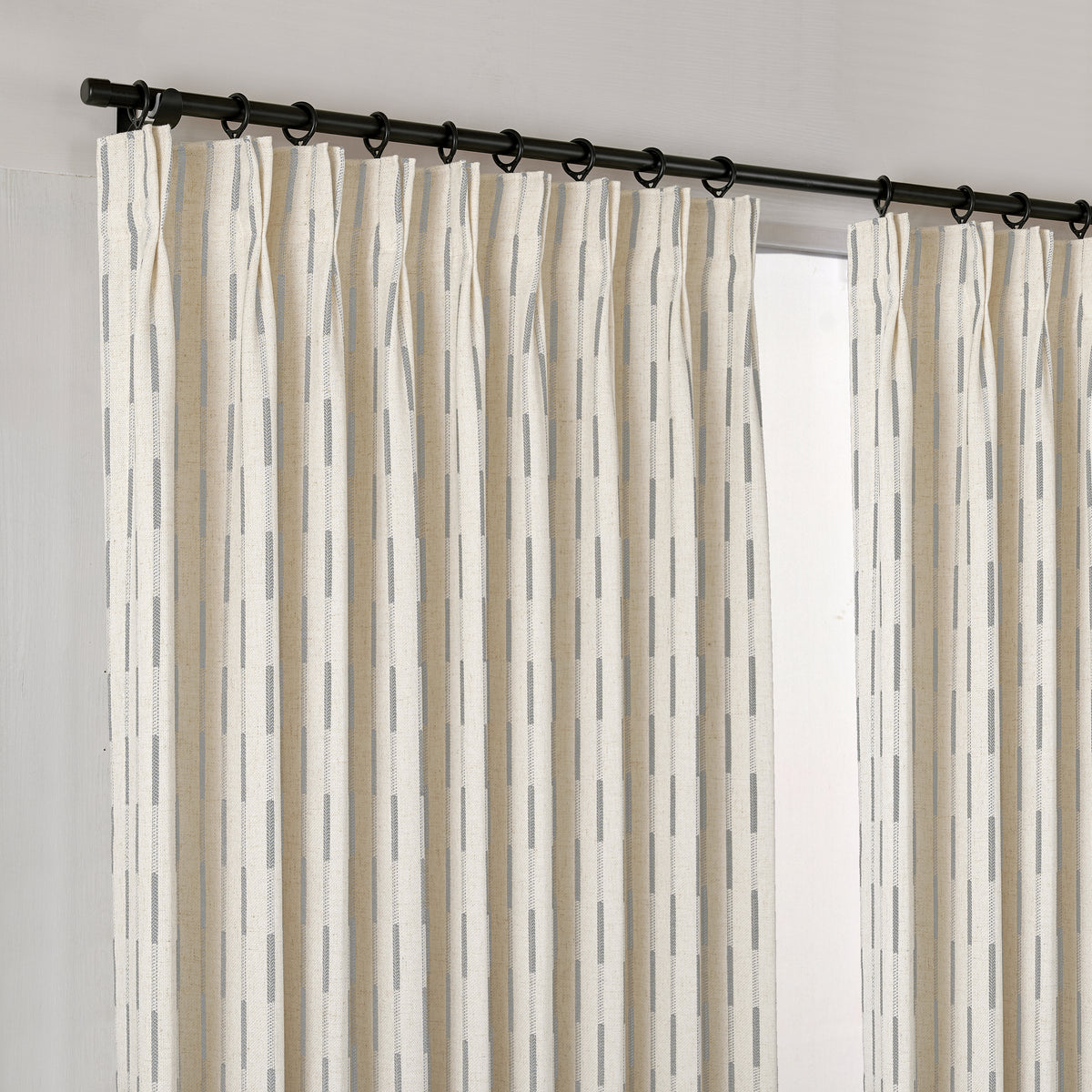 Ansel Dash Stripe Weave Curtains in Dove, hanging at the window