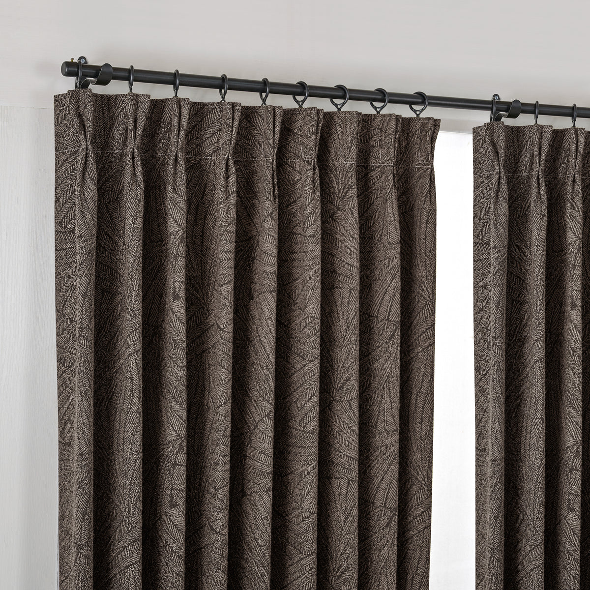 Bramwell Leaf Jacquard Blackout Curtains in Espresso, hanging at the window