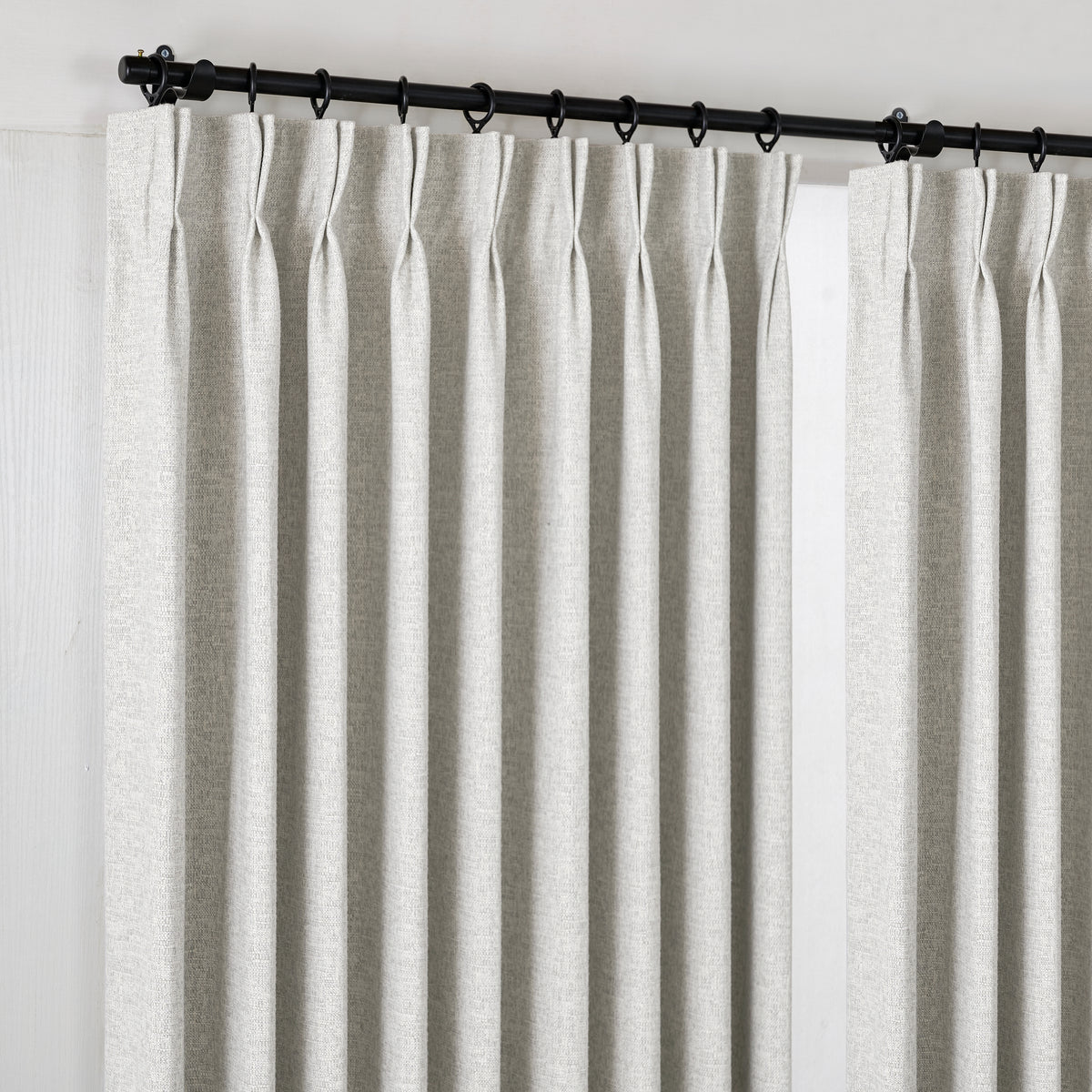 Everett Yarn-Dyed Jacquard Blackout Curtains in Greige, hanging at the window