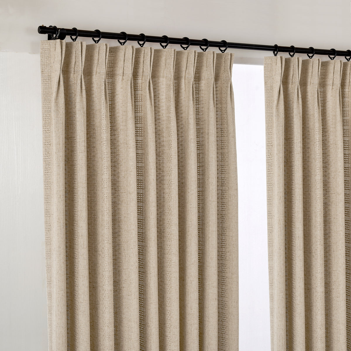 Ansel Eyelet Weave Curtains in Stone, hanging at the window