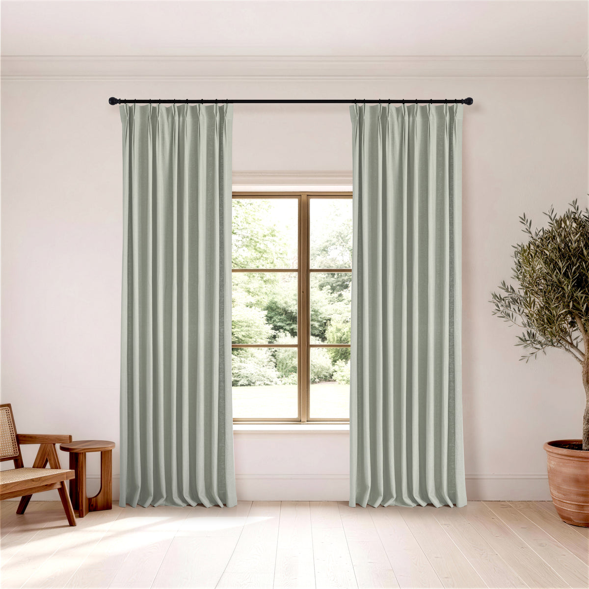 Edwina Linen-Cotton Curtains in Mist, hanging in a room
