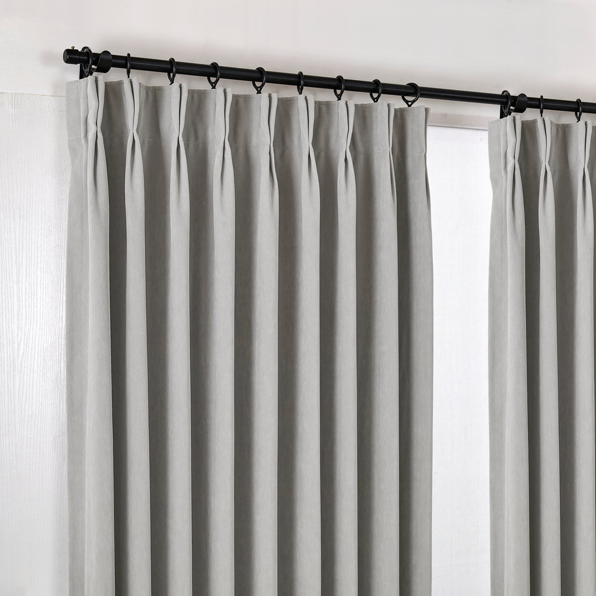 Genevieve Cloud-Soft Chenille Blackout Curtains in Pewter, hanging at the window