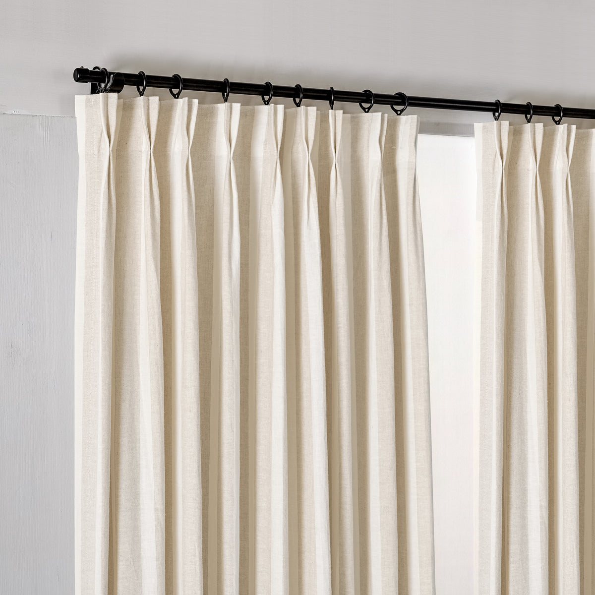 Carrick Striped Pure Linen Curtains in Flax Broad Stripe, hanging at the window