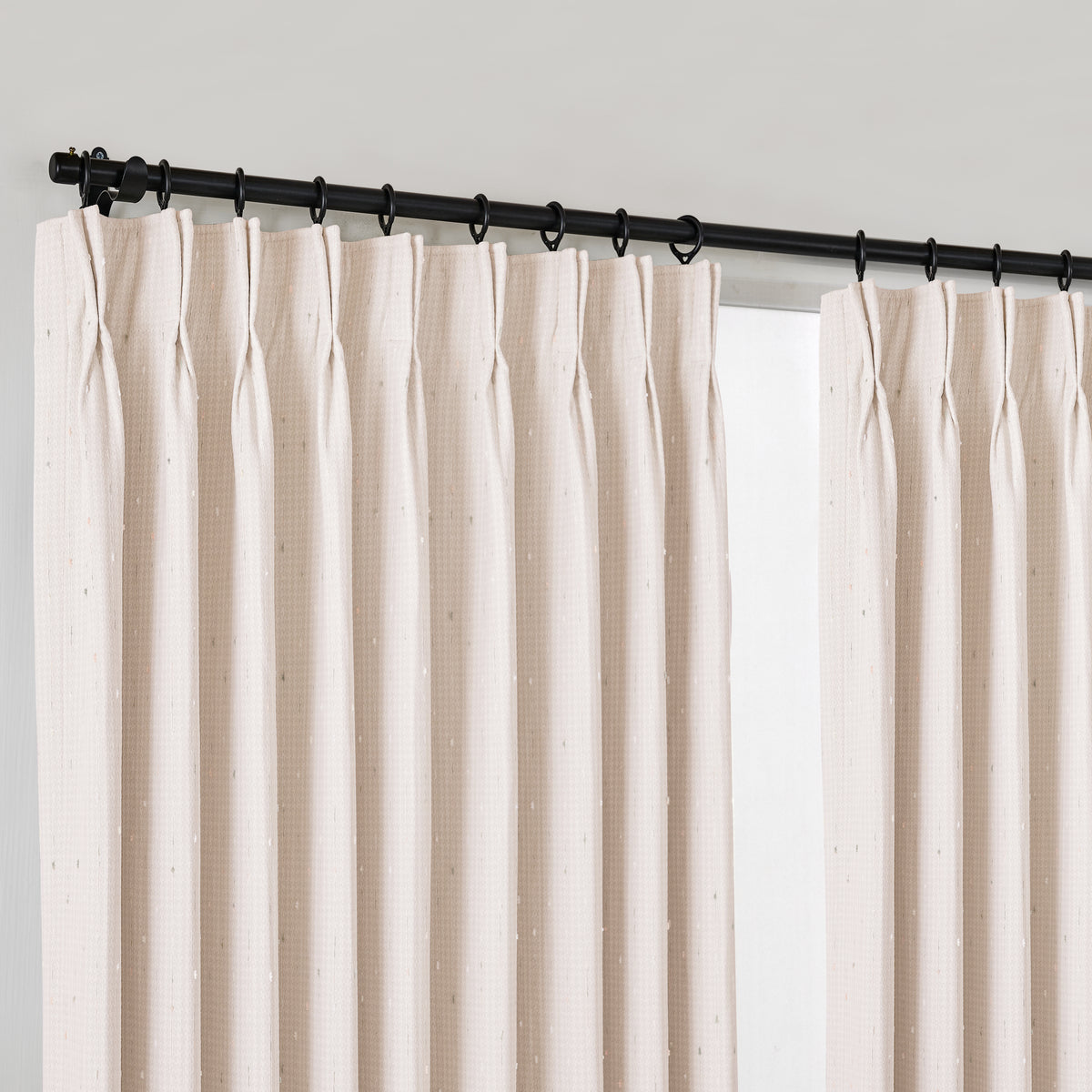 Clarice Tonal Jacquard Blackout Curtains in Light Pink, hanging at the window