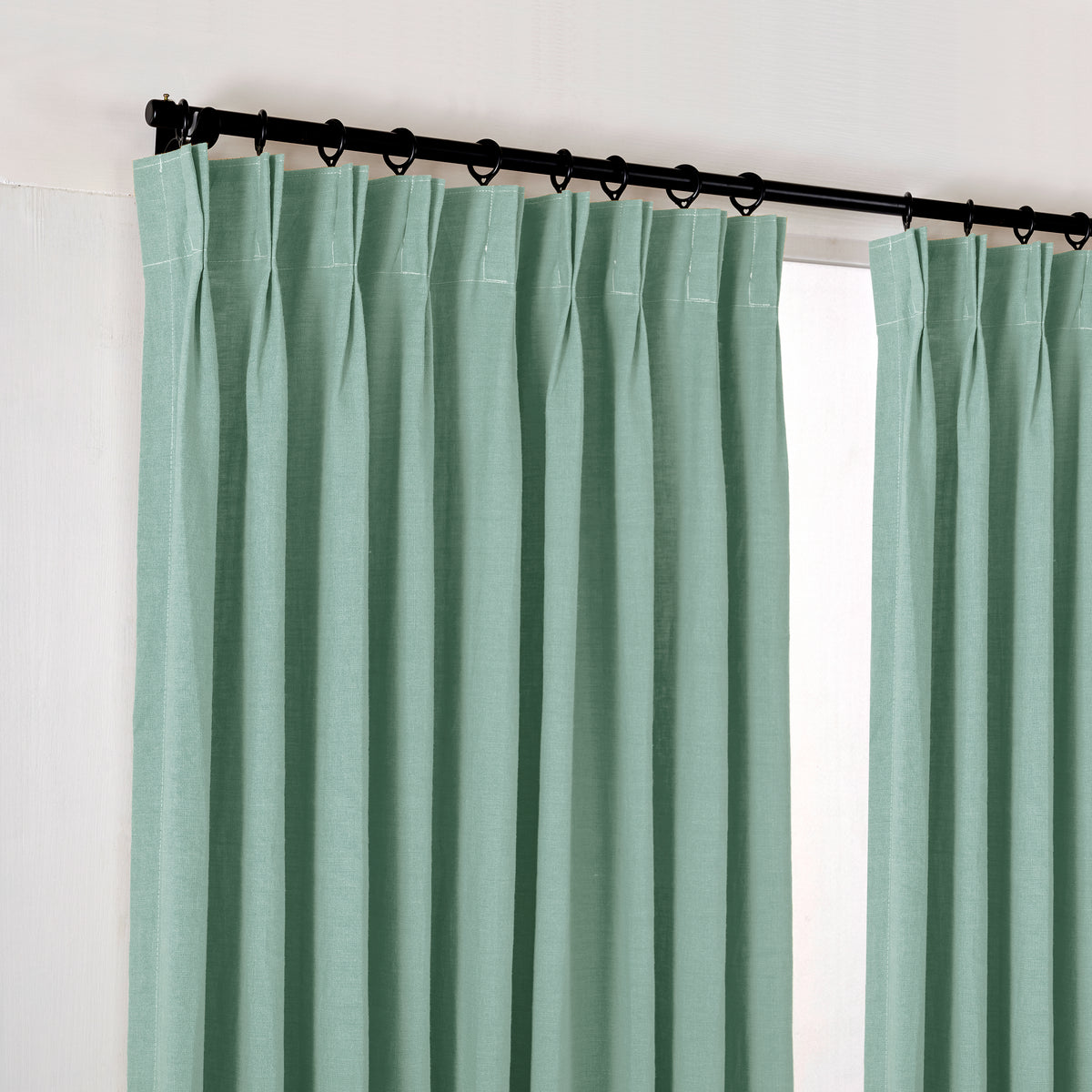 Ainsley Pure Linen Curtains in Eucalyptus, hanging at the window