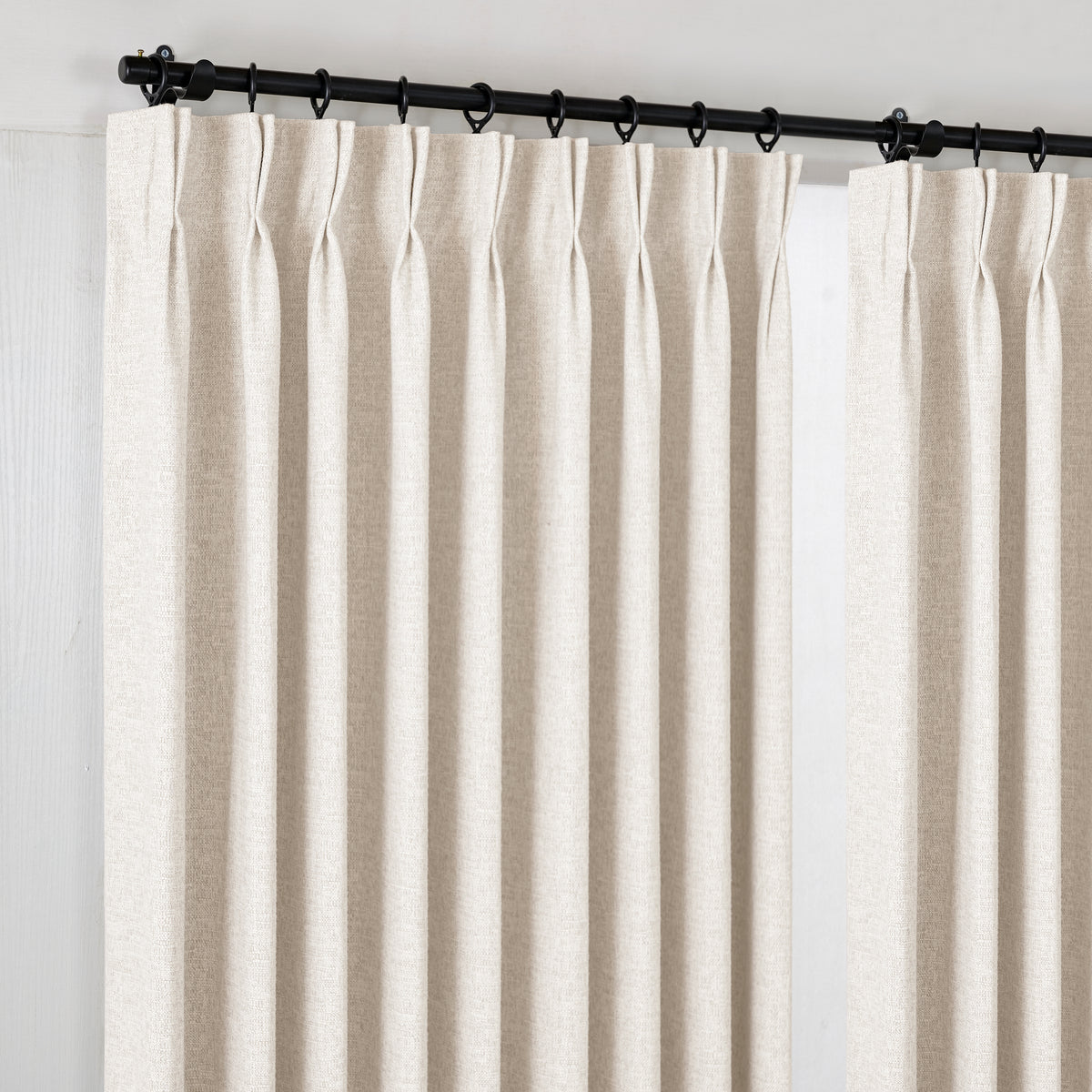 Everett Yarn-Dyed Jacquard Blackout Curtains in Ivory, hanging at the window