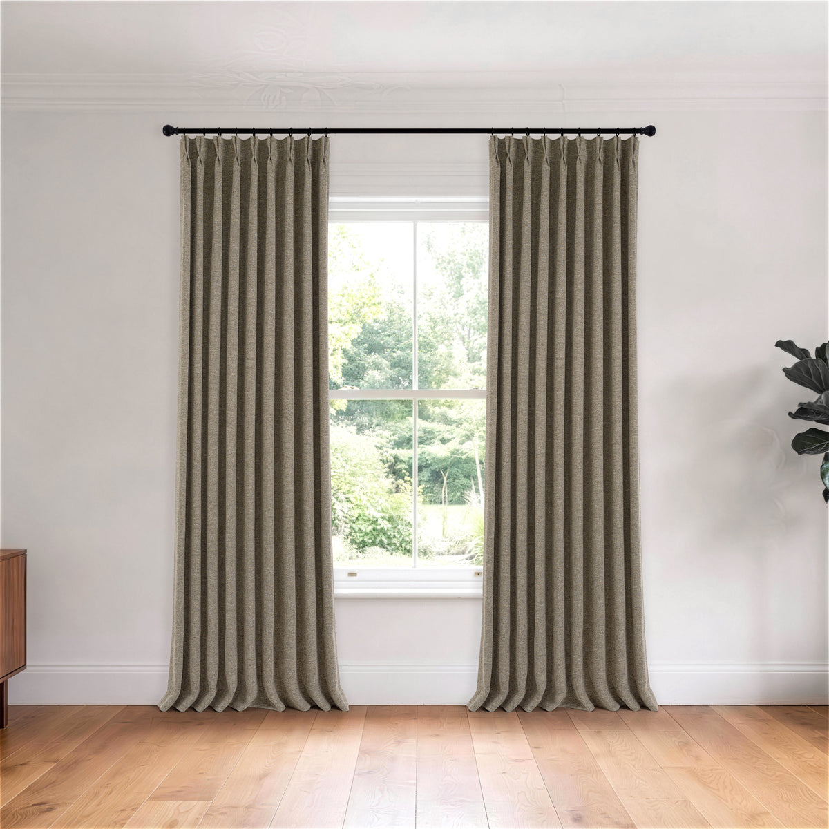 Tamsin Melange Weave Blackout Curtains in Stone, hanging in a room