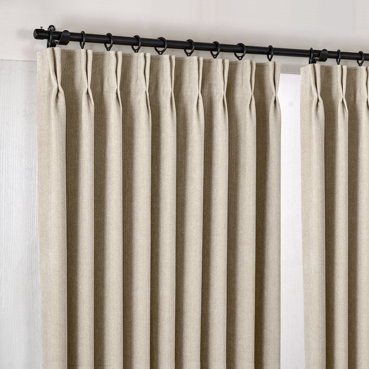 Hadleigh Herringbone Blackout Curtains in Greige, hanging at the window