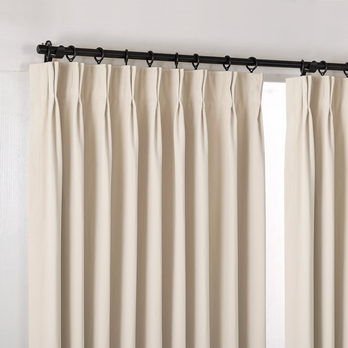 Sebastian Double-Faced Velvet Blackout Curtains in Warm Ivory, hanging at the window
