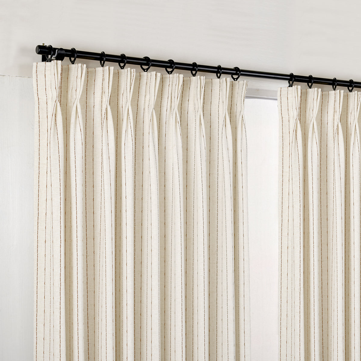 Ansel Pinstripe Weave Curtains in Ivory, hanging at the window