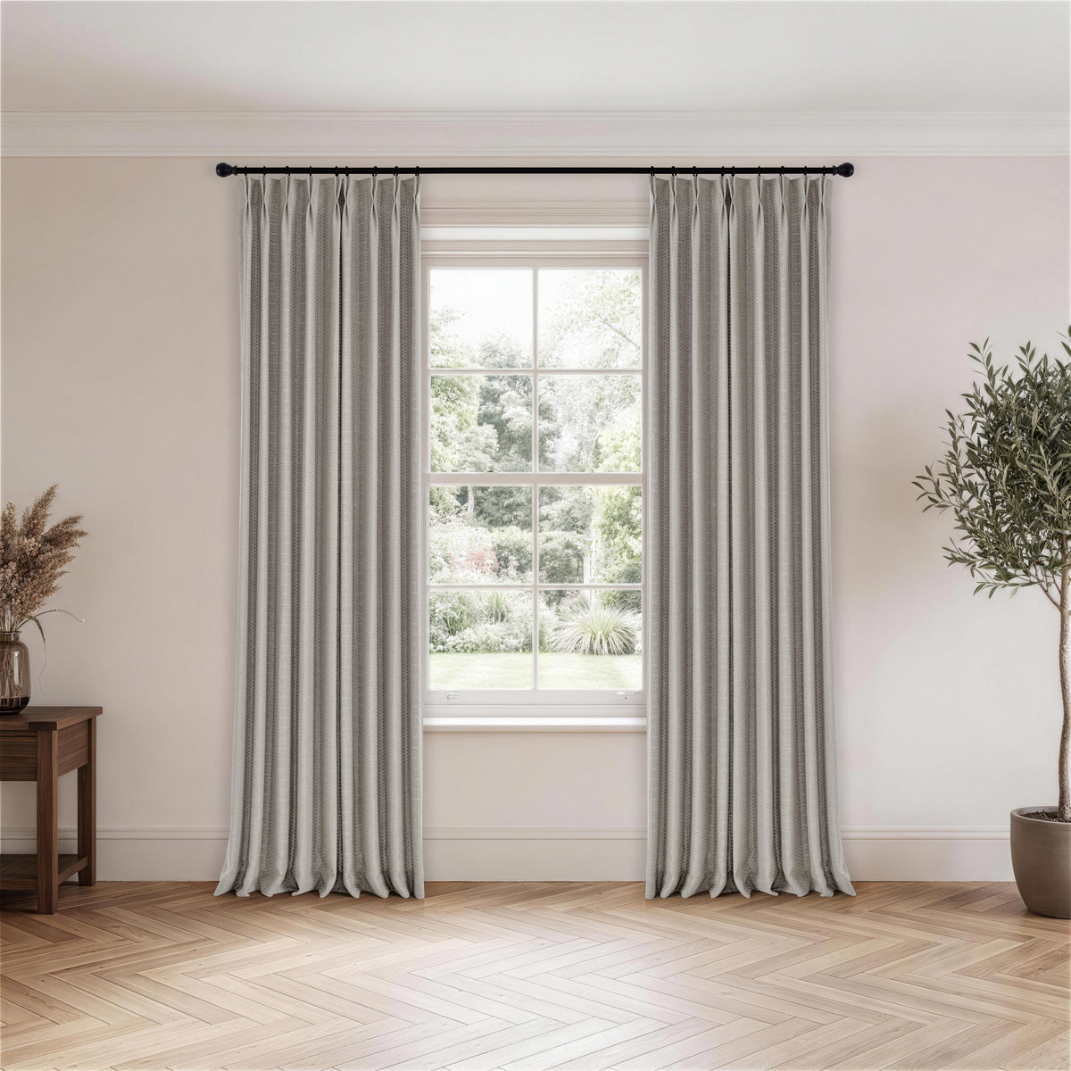 Ansel Eyelet Weave Curtains in Pewter, hanging in a room
