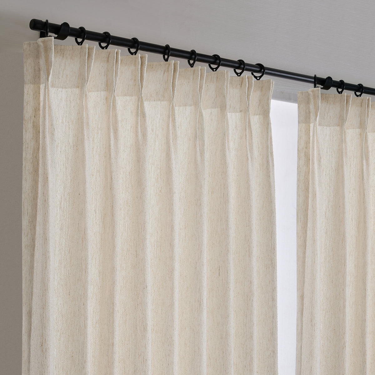 Noemi Open-Weave Sheer Curtains in Greige, hanging at the window