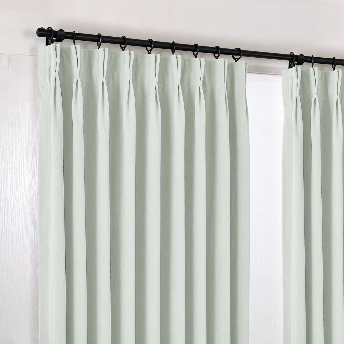 Genevieve Cloud-Soft Chenille Blackout Curtains in Mint, hanging at the window