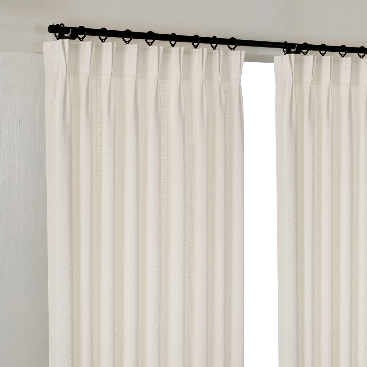Ansel Eyelet Weave Curtains in Deep Ivory, hanging at the window
