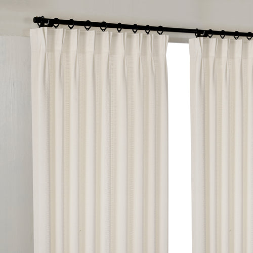Ansel Eyelet Weave Curtains in Deep Ivory, hanging at the window