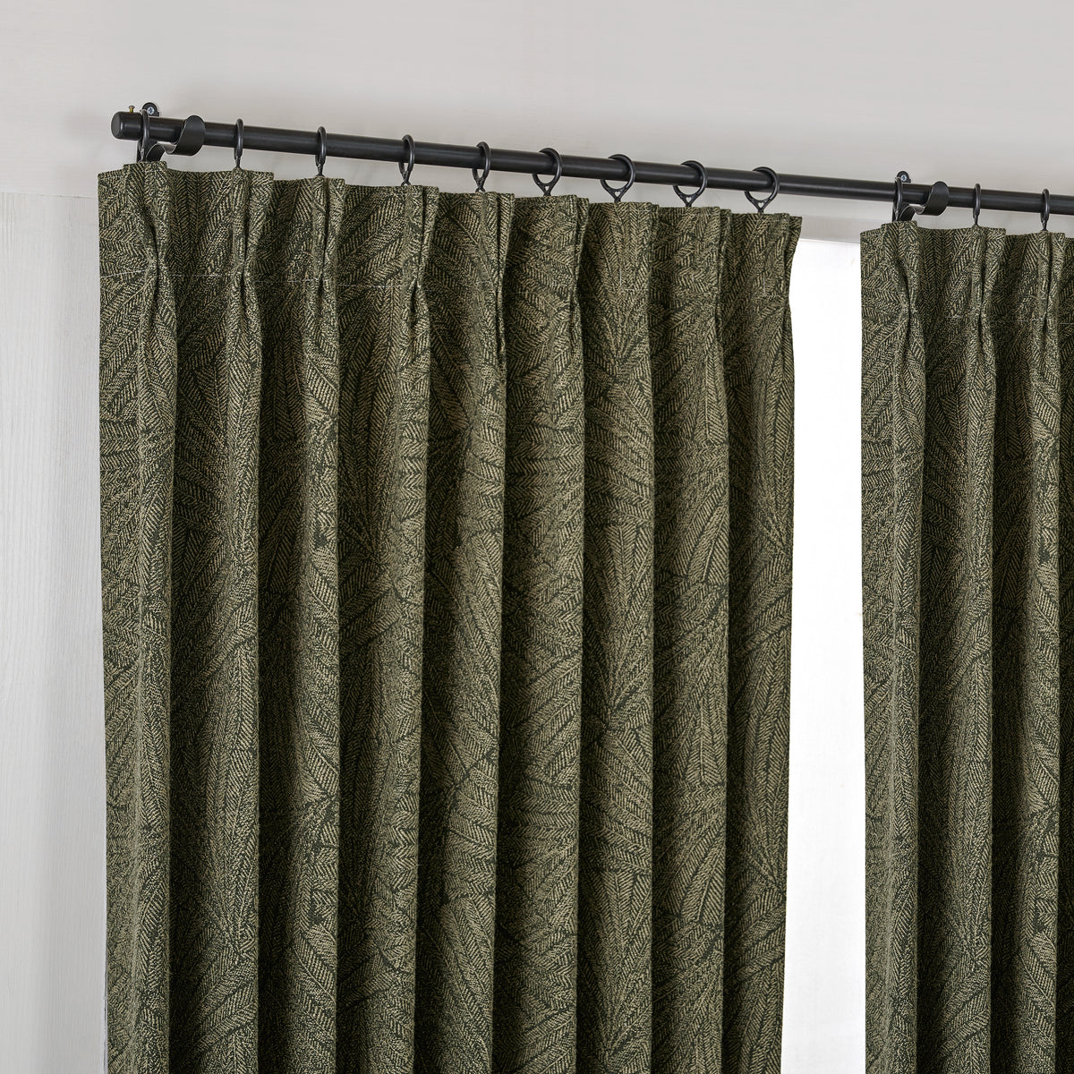 Bramwell Leaf Jacquard Blackout Curtains in Dark Olive, hanging at the window