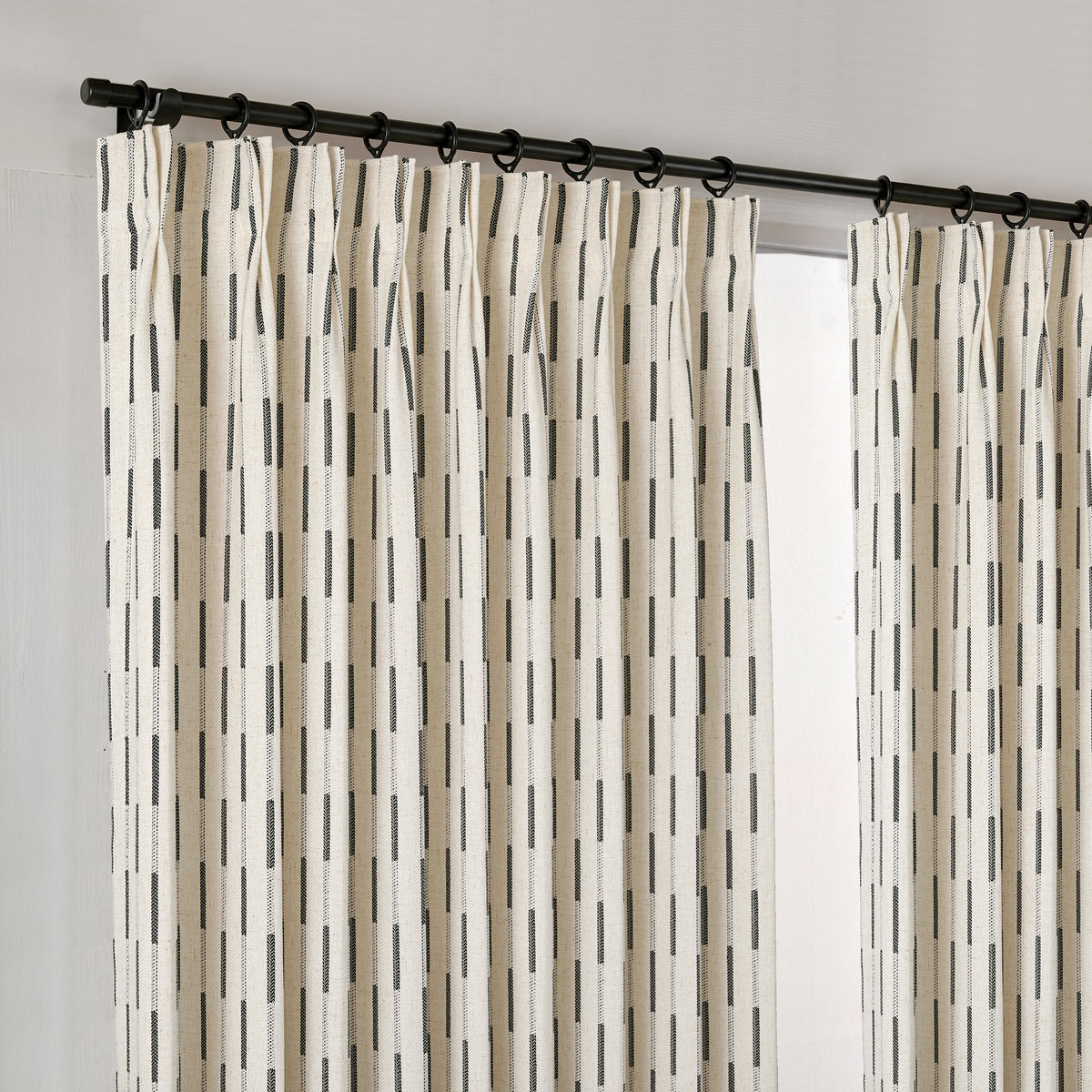 Ansel Dash Stripe Weave Curtains in Charcoal, hanging at the window