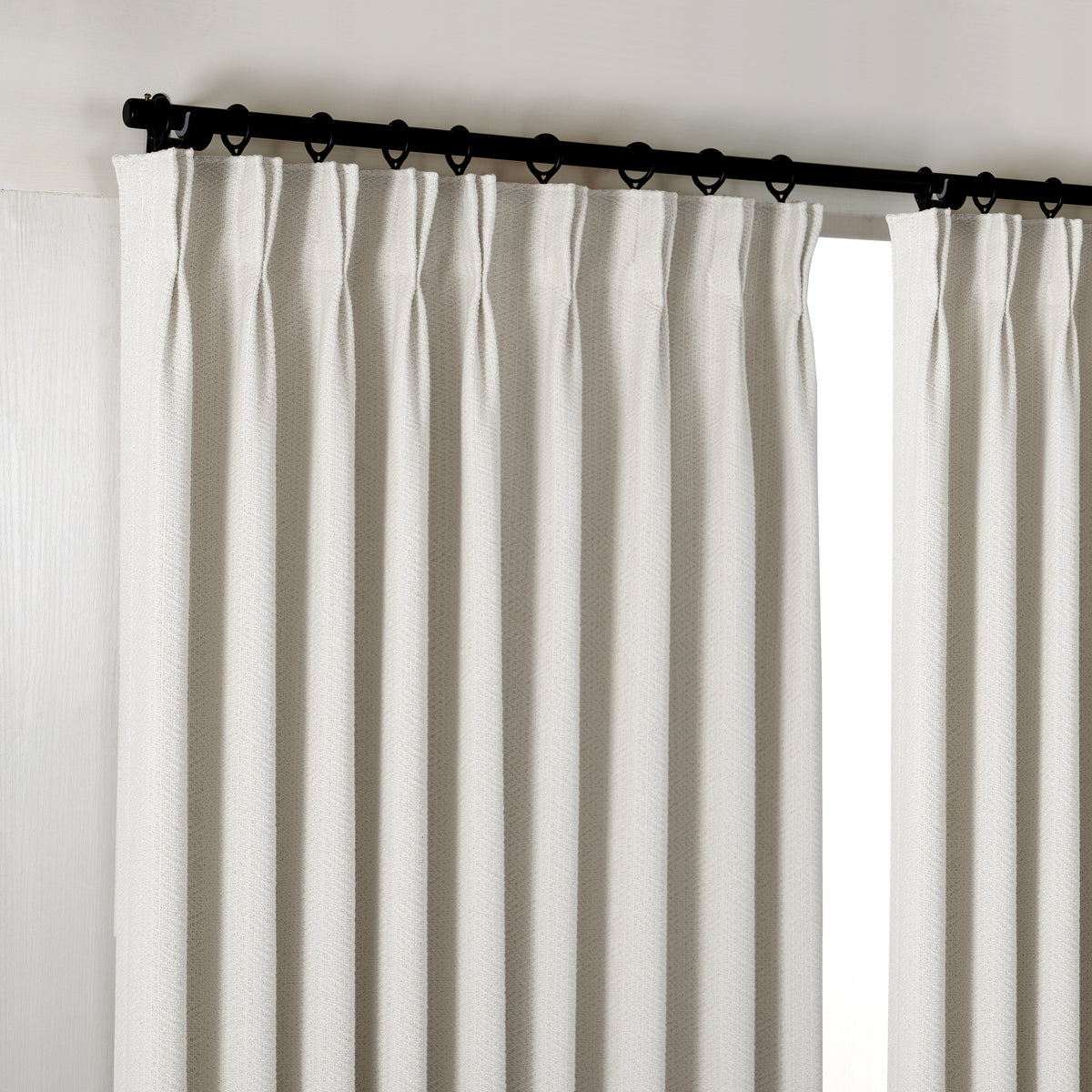 Pembroke Chevron Weave Curtains in Cool Greige, hanging at the window