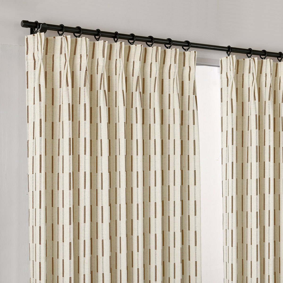 Ansel Dash Stripe Weave Curtains in Caramel, hanging at the window