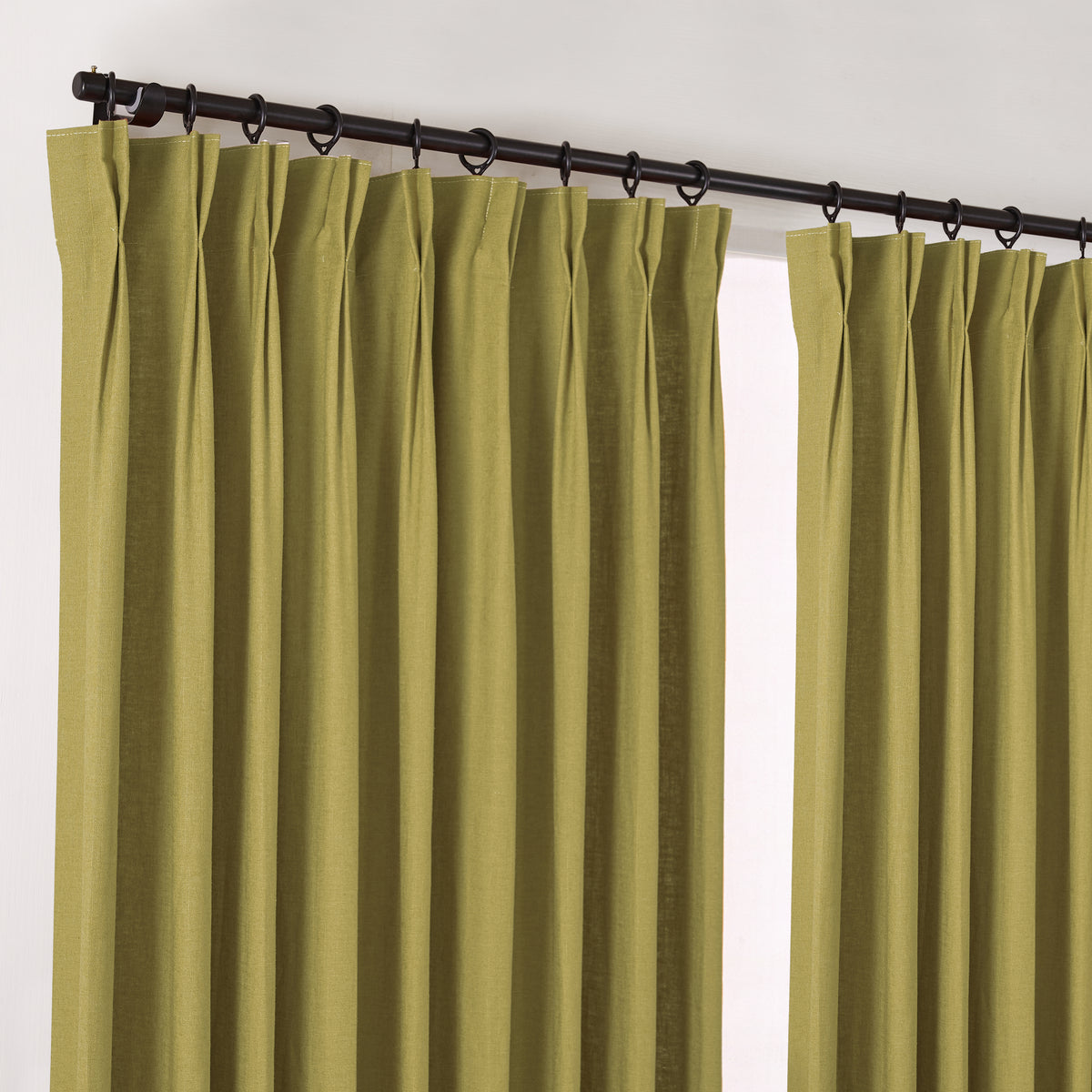 Edwina Linen-Cotton Curtains in Olive, hanging at the window