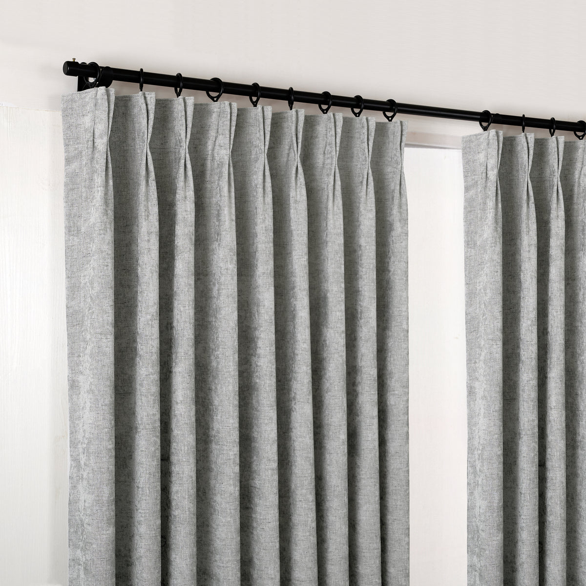 Prentiss Reversible Slub Curtains in Pewter, hanging at the window