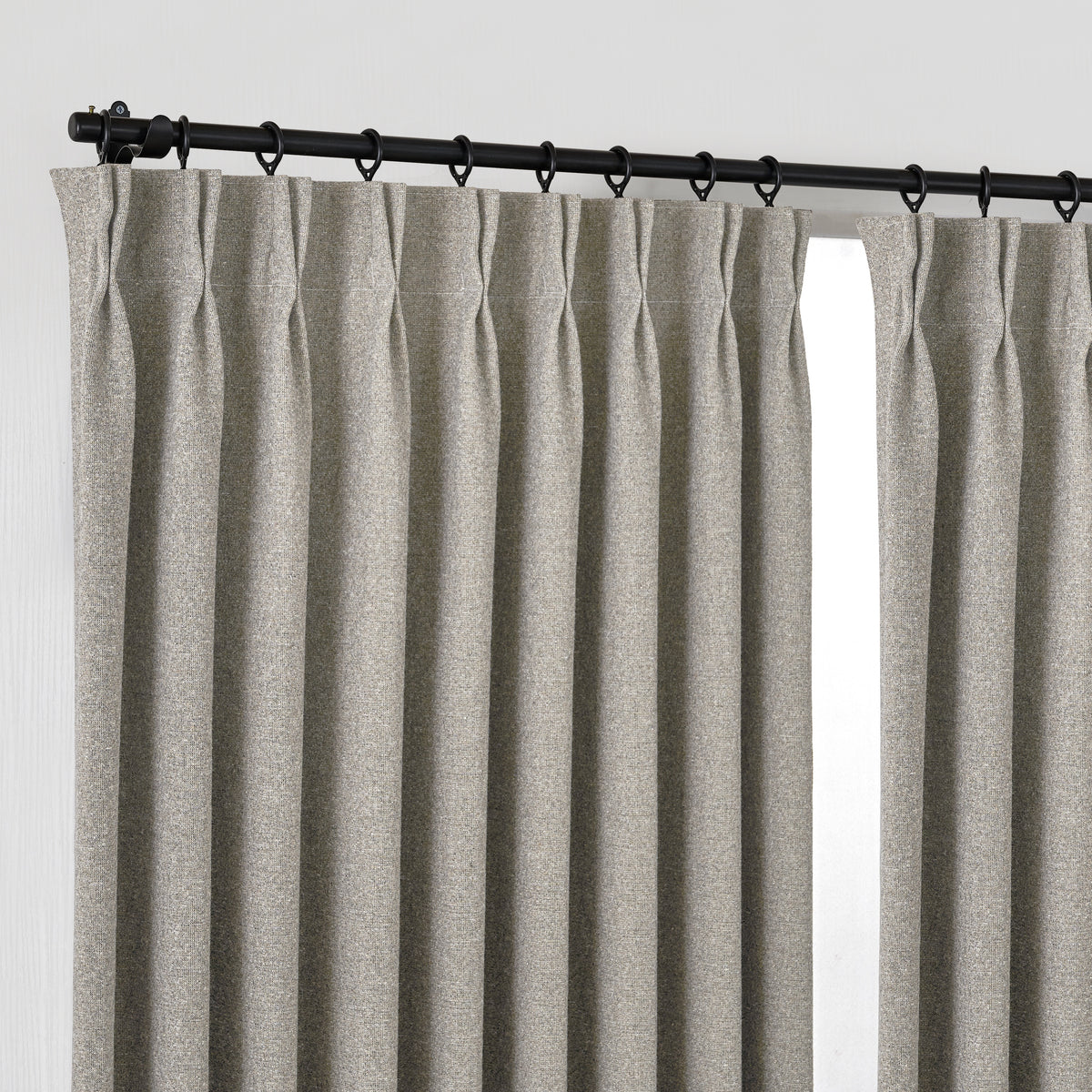 Fraser Wool-Blend Blackout Curtains in Stone, hanging at the window