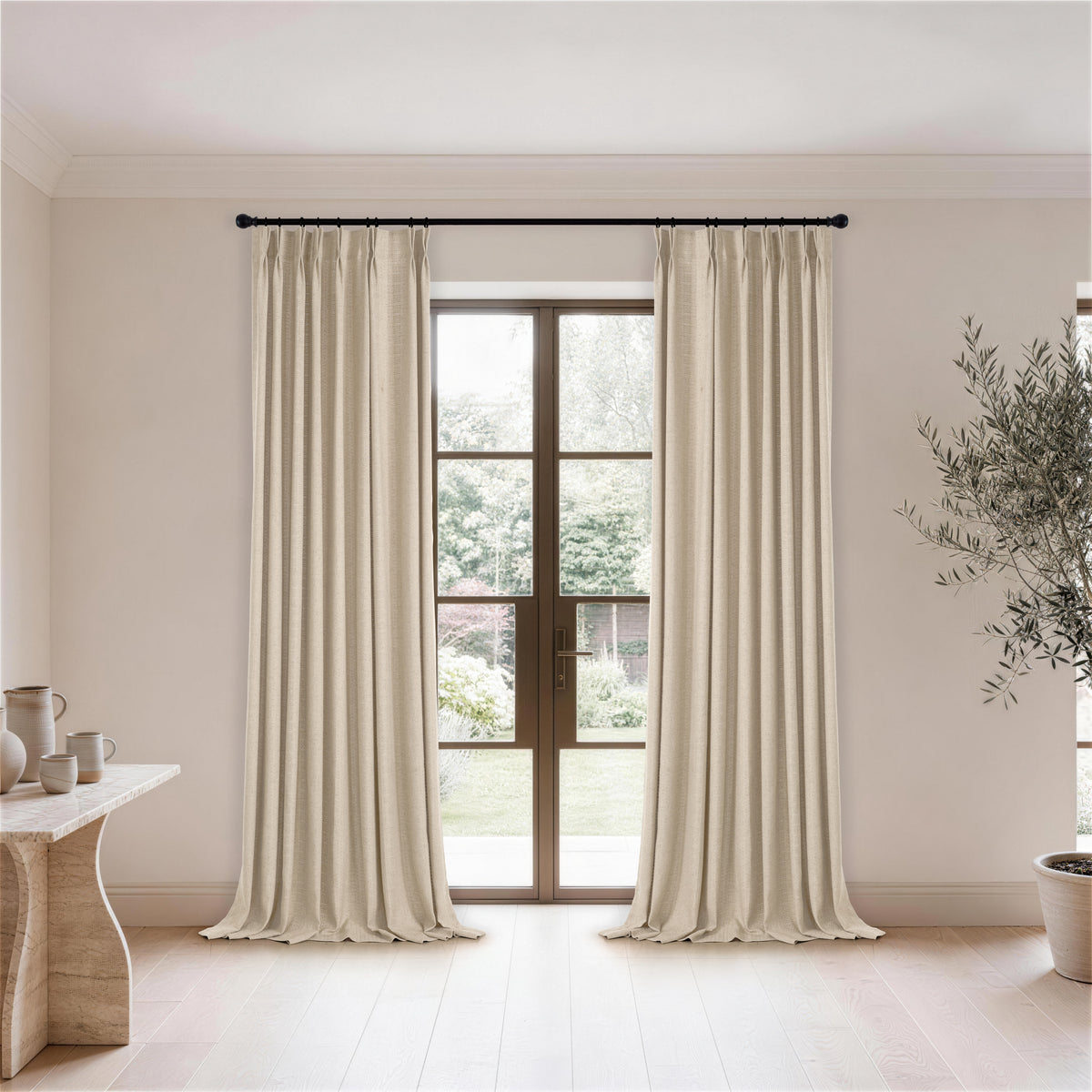 Ansel Eyelet Weave Curtains in Warm Greige, hanging in a room