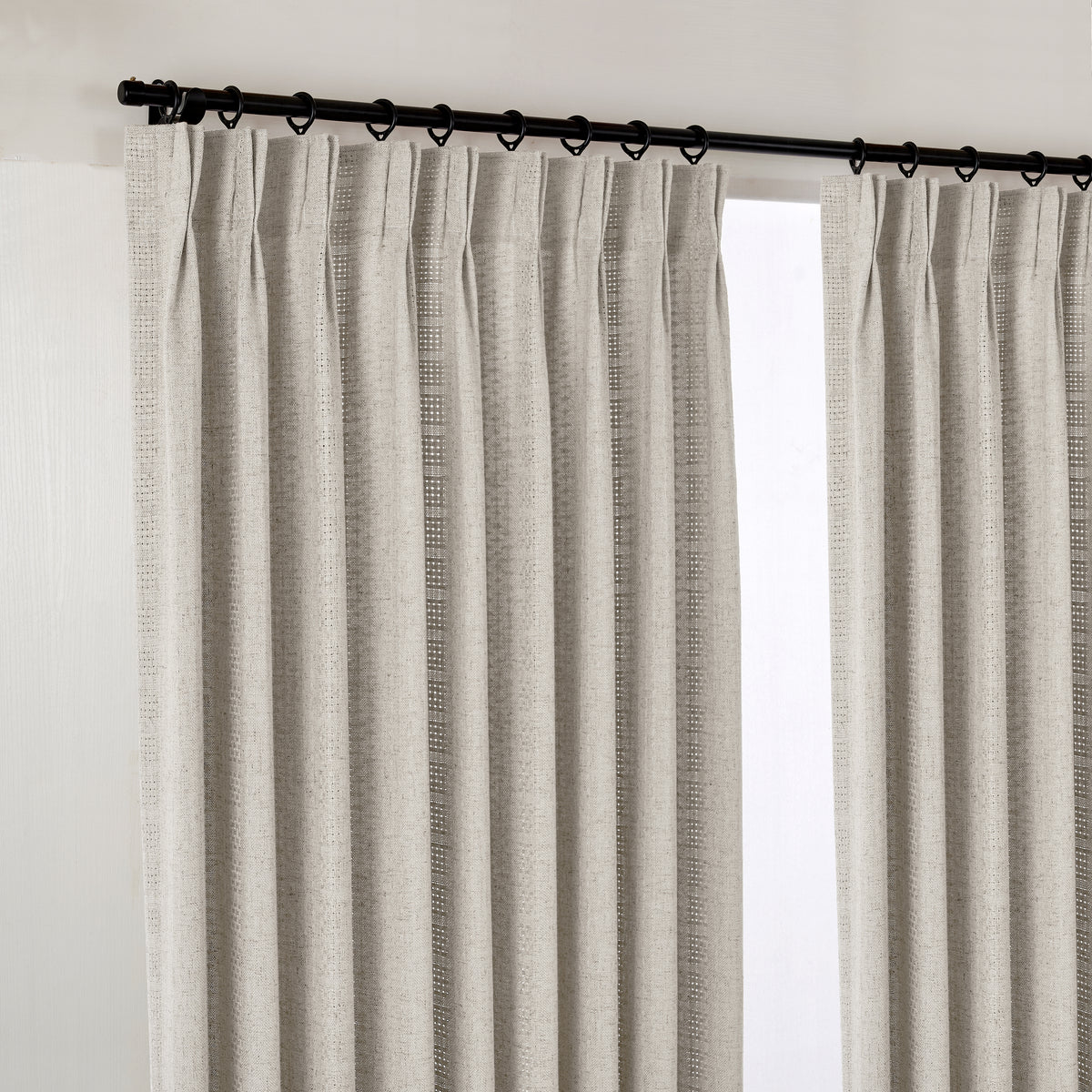 Ansel Eyelet Weave Curtains in Greige, hanging at the window