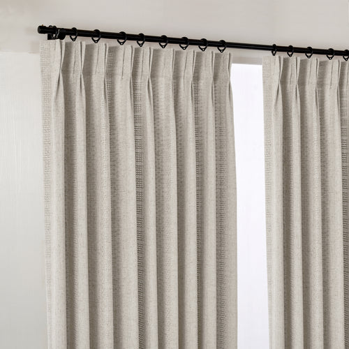 Ansel Eyelet Weave Curtains in Greige, hanging at the window