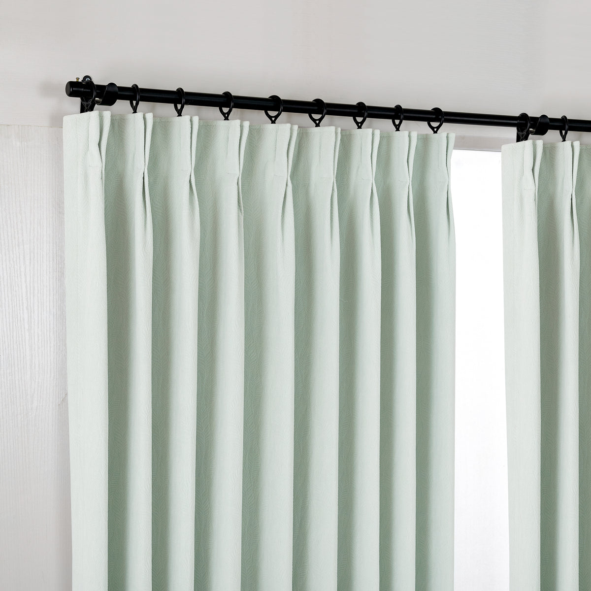 Cordelia Sculpted Chenille Blackout Curtains in Seafoam, hanging at the window