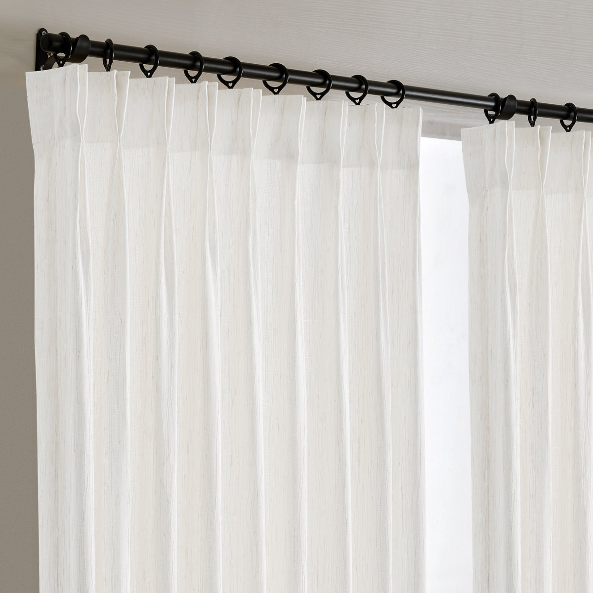Odile Vine Sheer Curtains in White, hanging at the window