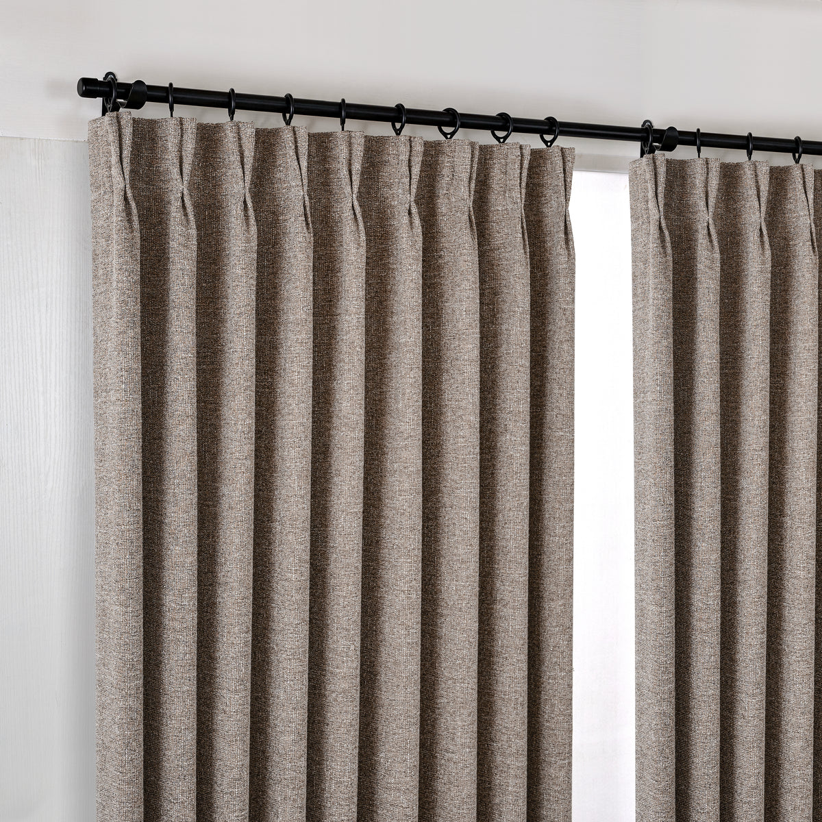 Tamsin Melange Weave Blackout Curtains in Cool Stone, hanging at the window