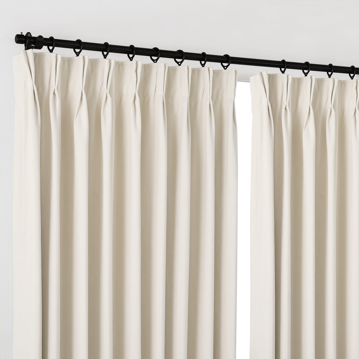 Genevieve Cloud-Soft Chenille Blackout Curtains in Ivory, hanging at the window