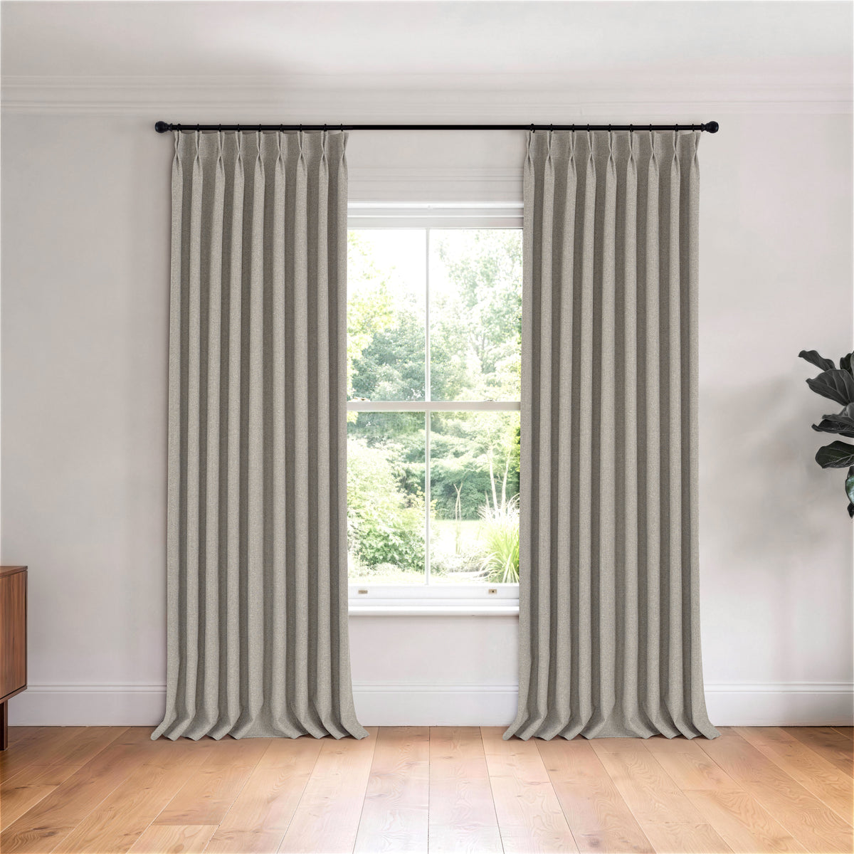 Fraser Wool-Blend Blackout Curtains in Stone, hanging in a room
