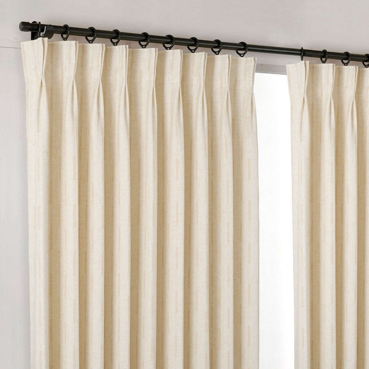 Ansel Dash Stripe Weave Curtains in Ivory, hanging at the window