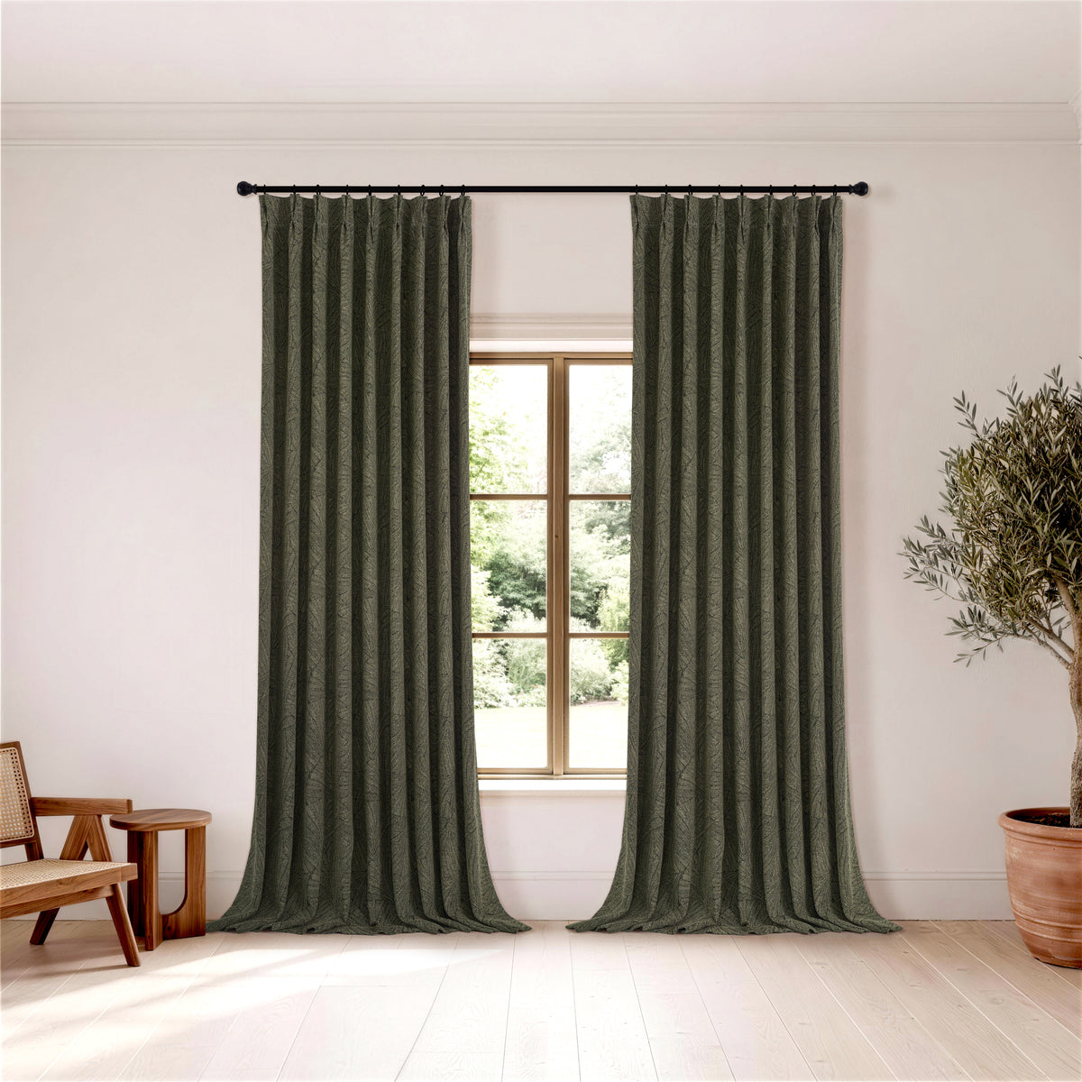Bramwell Leaf Jacquard Blackout Curtains in Dark Olive, hanging in a room