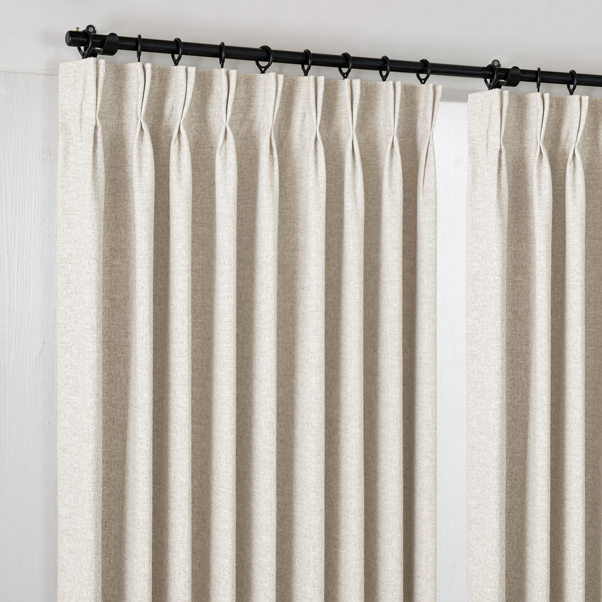 Everett Yarn-Dyed Jacquard Blackout Curtains in Oat, hanging at the window