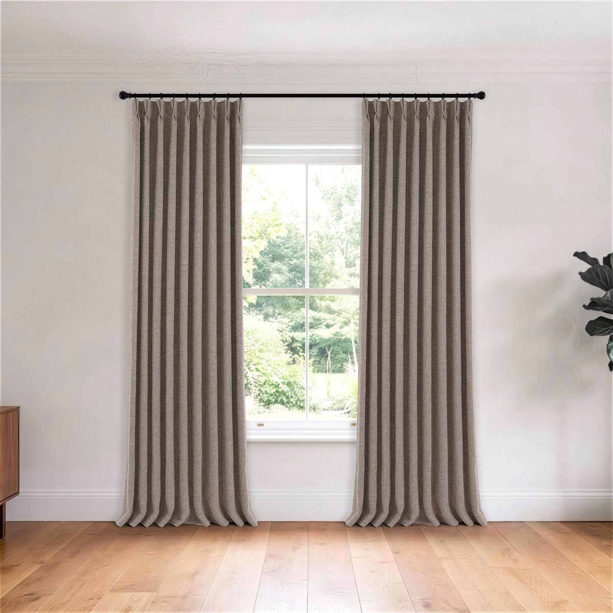 Tamsin Melange Weave Blackout Curtains in Cool Stone, hanging in a room