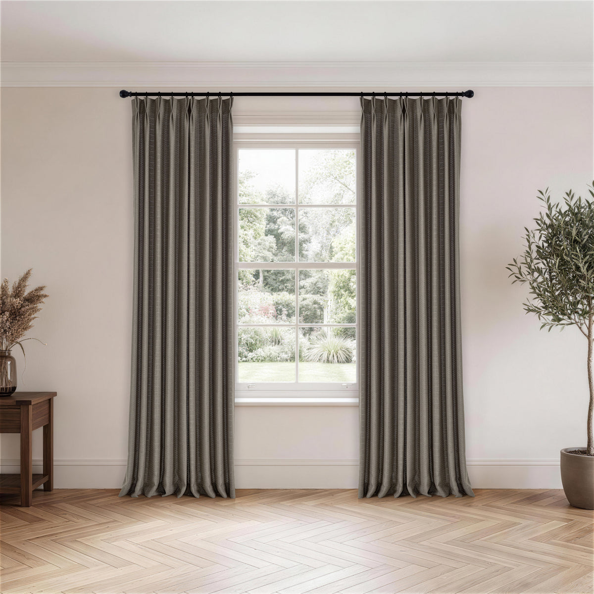 Ansel Eyelet Weave Curtains in Charcoal, hanging in a room