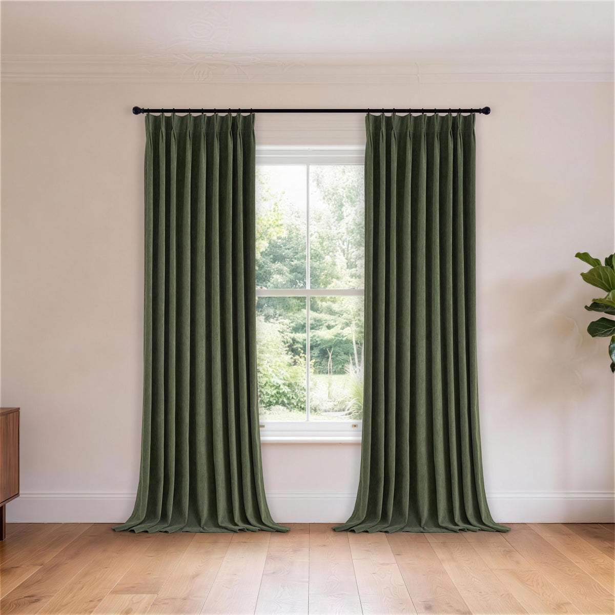 Cordelia Sculpted Chenille Blackout Curtains in Forest, hanging in a room