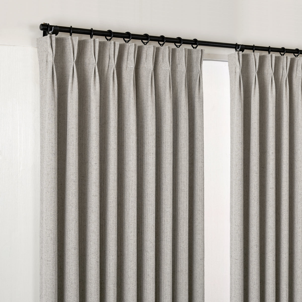 Ansel Slub Weave Curtains in Pewter, hanging at the window
