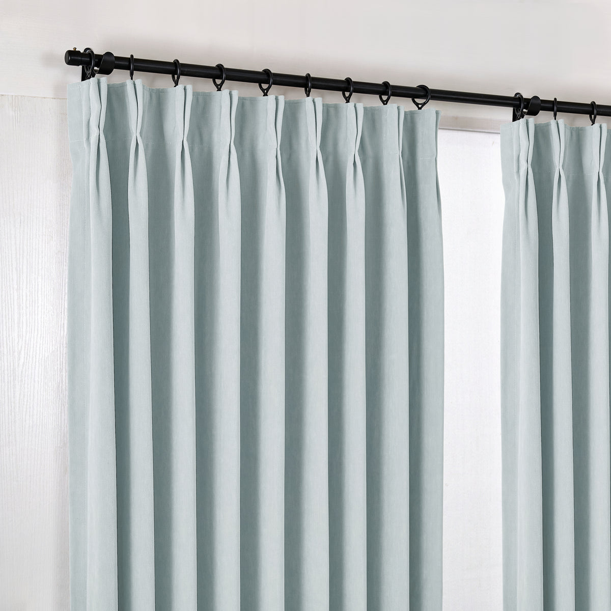 Genevieve Cloud-Soft Chenille Blackout Curtains in Dusty Blue, hanging at the window